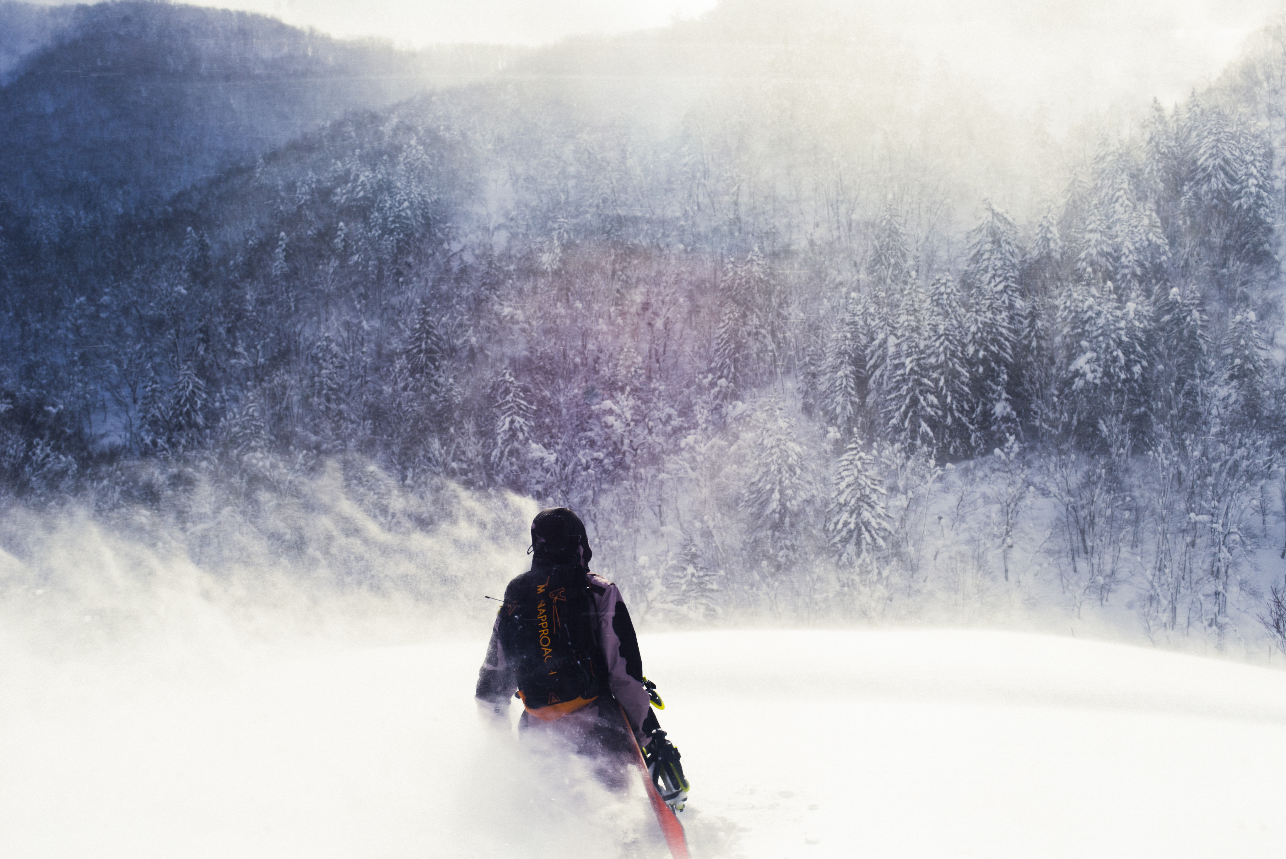 snowboarder on walking in the mountains